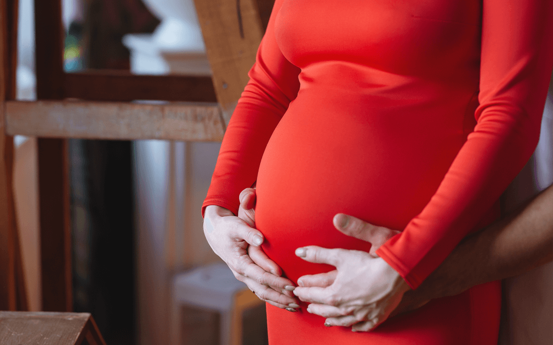 Mum and Dad holding the mum's baby bump